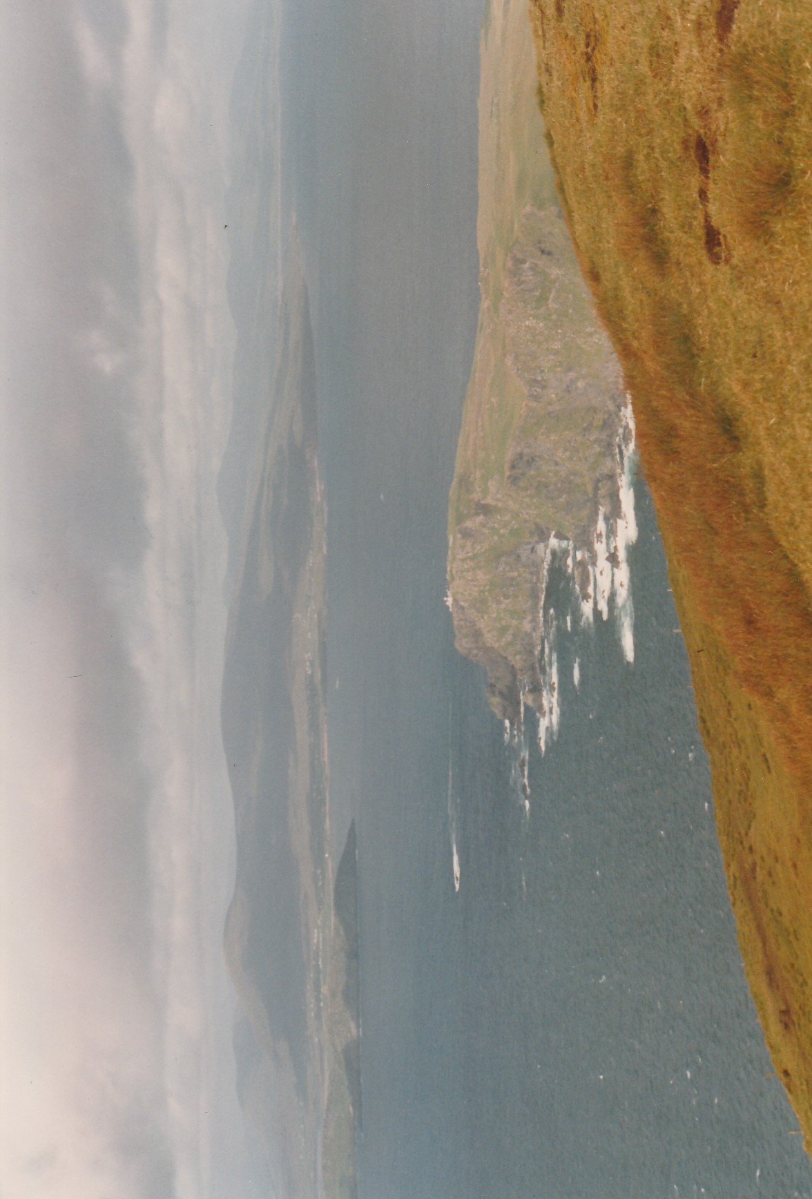 Wide 1994 view across the Atlantic to Clare Island Lighthouse, small on the high northern headland.