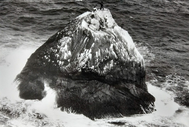 Members of the 1971–72 expedition scaling Rockall before installation of the navigation beacon.