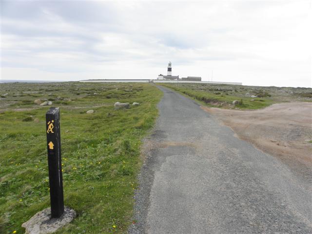 Walking towards Tory Island lighthouse on the Donegal coast.